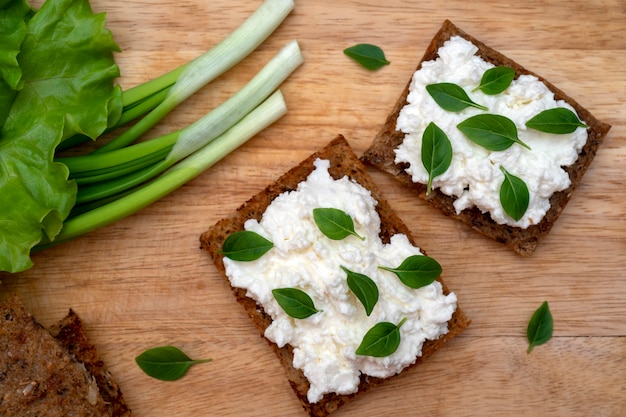 Healthy fresh vegetables and greens on crisp bread.