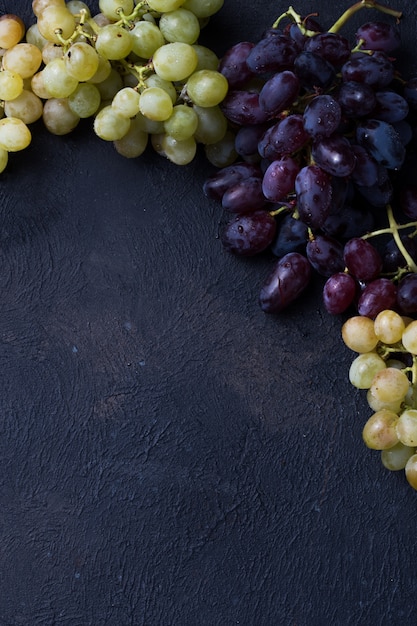 Healthy fruits Red and White wine grapes on stone surface s