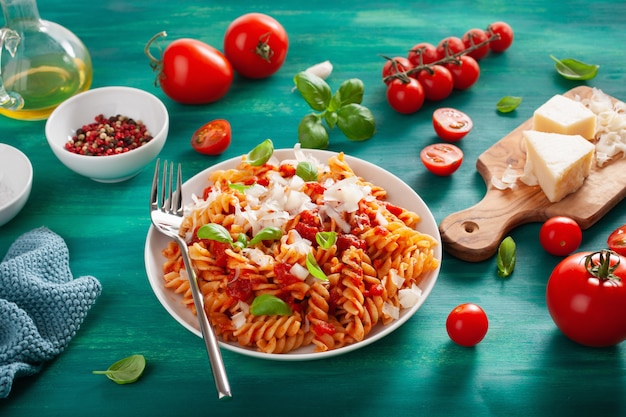 Healthy fusilli pasta with tomato sauce parmesan basil