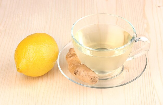 Healthy ginger tea with lemon on wooden background