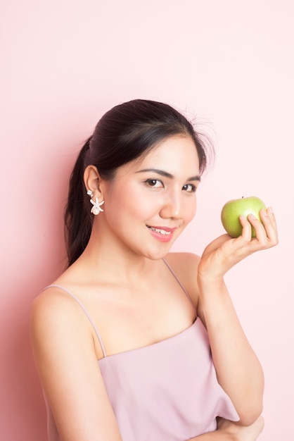 Healthy girl eating green apple 