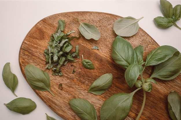 Healthy green basil with a knife on wooden board background free space for text