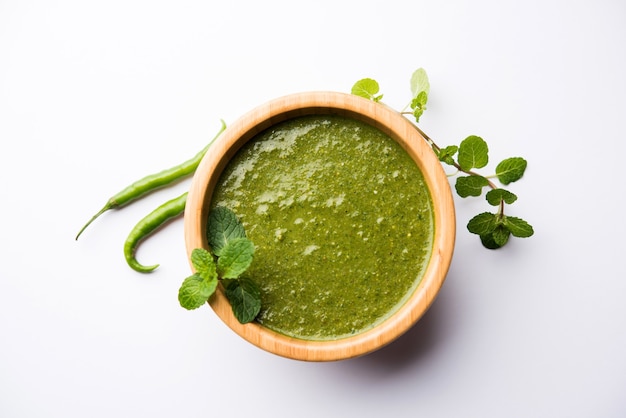 Healthy Green Mint Chutney Made with Coriander, pudina And Spices. isolated moody background. selective focus