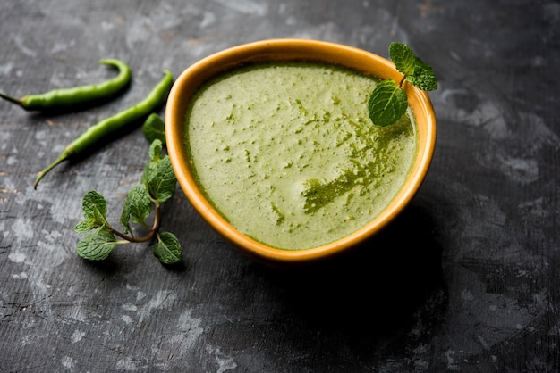 Healthy Green Mint Chutney Made with Coriander, pudina And Spices. isolated moody background. selective focus