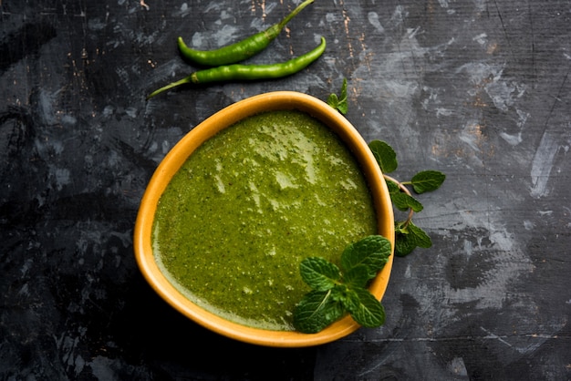 Healthy Green Mint Chutney Made with Coriander, pudina And Spices. isolated moody background. selective focus