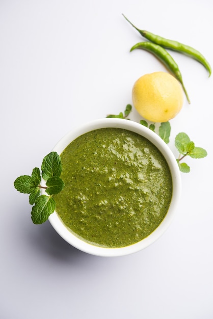 Healthy Green Mint Chutney Made with Coriander, pudina And Spices. isolated moody background. selective focus