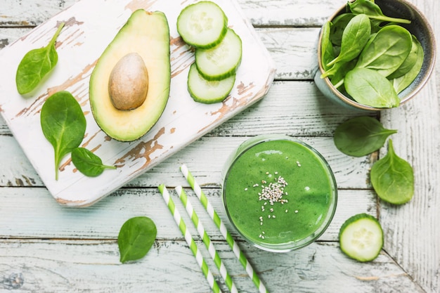 Healthy green smoothie with spinach avocado banana and chia seeds on white