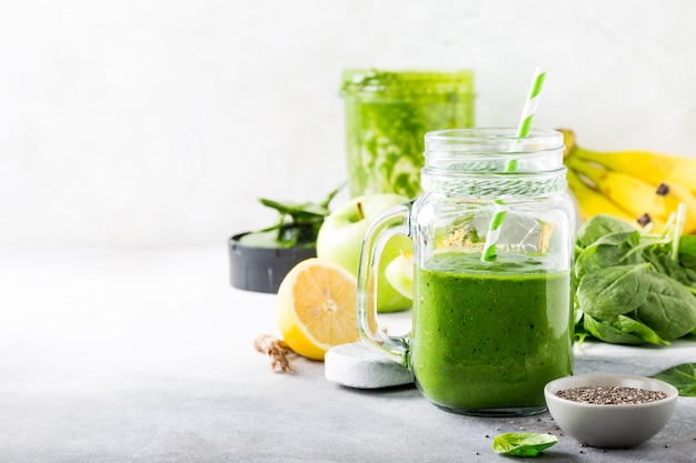 Healthy green smoothie with spinach in glass jar