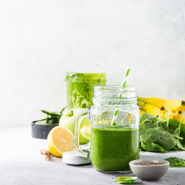 Healthy green smoothie with spinach in glass jar