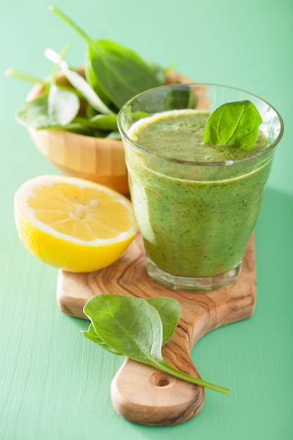 Healthy green smoothie with spinach leaves apple lemon