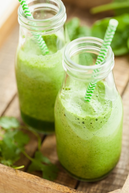Healthy green spinach smoothie with cilantro lime banana ginger