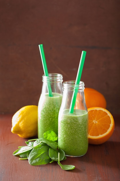 Healthy green spinach smoothie with lemon orange