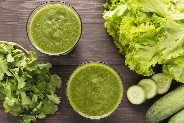 Healthy green vegetables smoothie on rustic wood table