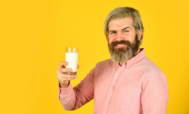 Healthy habits lactose free vegan milk concept bearded man hold glass of milk pasteurized milk vegan milks made from wide variety of beans nut seeds and grains drink protein cocktail
