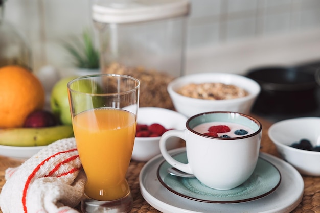 healthy and healthy breakfast with juice fruits yogurt berries and muesli