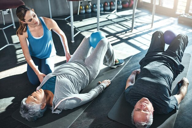 Healthy hearts are happy hearts Shot of two seniors working out with a physiotherapist