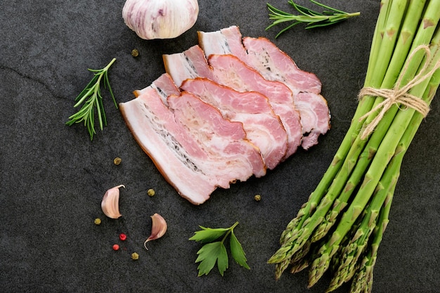 Healthy homemade eating concept ingredients for meal of green asparagus with tasty smoked bacon and spices