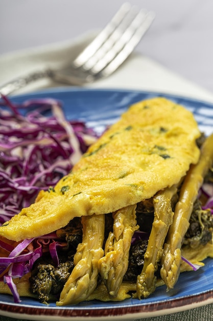 Healthy Homemade Green Asparagus Omelette with Spinach and Purple Cabbage with copy space. Vegan food concept