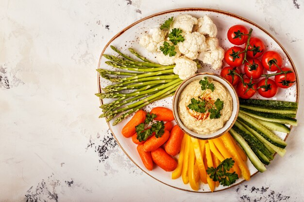 Healthy homemade hummus with assorted fresh vegetables.