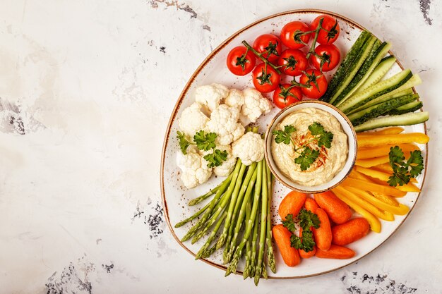 Healthy homemade hummus with assorted fresh vegetables