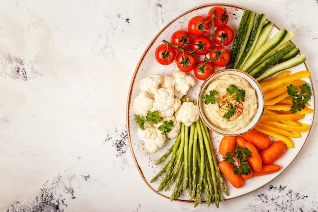 Healthy homemade hummus with assorted vegetables