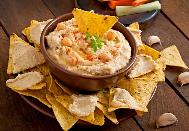 healthy homemade hummus with olive oil and pita chips