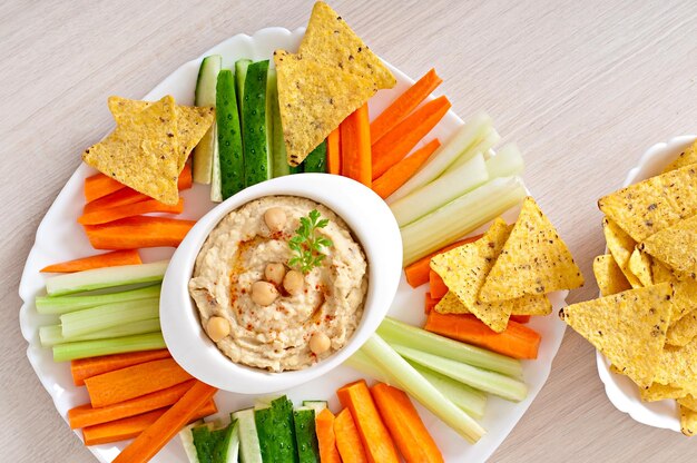 Healthy homemade hummus with olive oil and pita chips