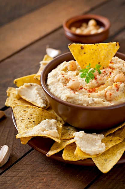 Healthy homemade hummus with olive oil and pita chips