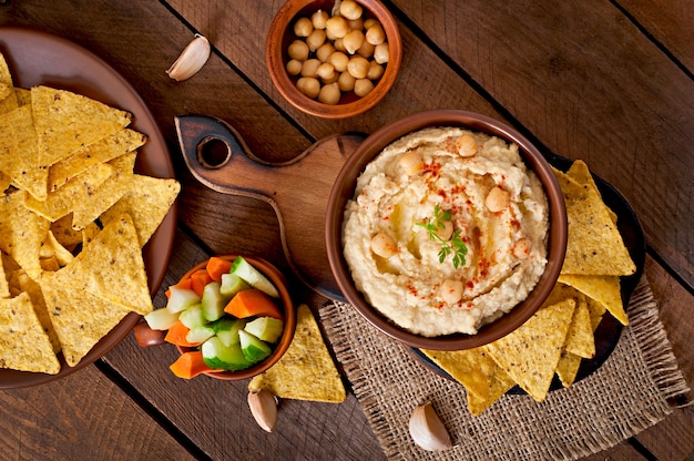 healthy homemade  hummus with olive oil and pita chips