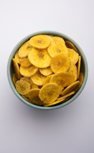 Healthy Homemade Kela or Banana chips or wafers served over moody background, selective focus