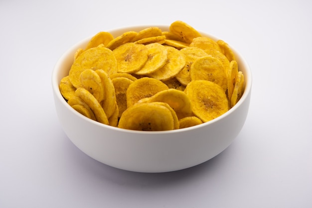 Healthy Homemade Kela or Banana chips or wafers served over moody background, selective focus