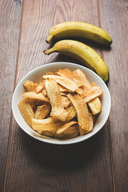 Healthy Homemade Kela or Banana chips or wafers served over moody surface, selective focus