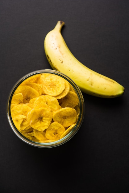 Healthy Homemade Kela or Banana chips or wafers served over moody surface, selective focus