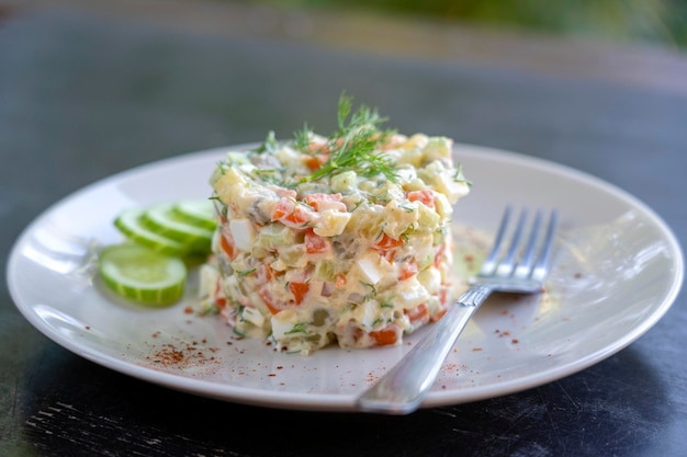 Healthy homemade russian traditional salad olivier ready to eat close up