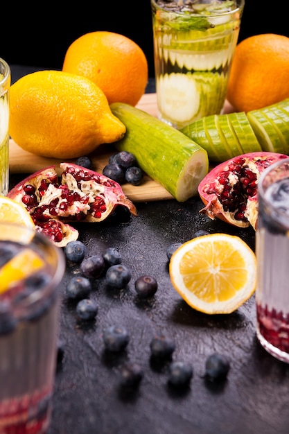 Healthy homemade vitamin water from fruits and vegetables on dark vintage wooden background