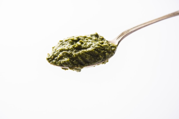 Healthy Indian Green Chutney or Sauce Made using Coriander, Mint And Spices. isolated over moody background. Selective focus