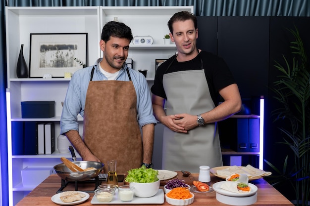 Healthy influencers presenting fresh salad roll power on cooking show displaying ingredients of diversity vegetables and homemade soft tortilla wrap on table Channel on social media live Sellable