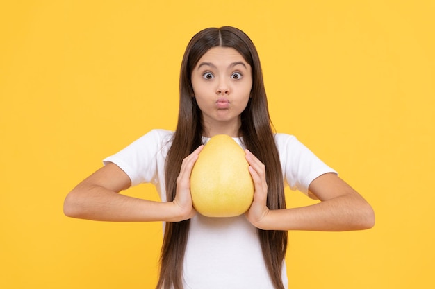 Healthy life diet and kid beauty surprised teen girl with pomelo citrus fruit vitamin and dieting