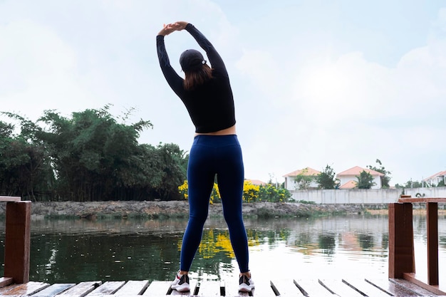 Healthy lifestyle Healthy young woman warming up outdoors