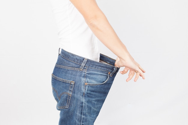 Healthy lifestyles  Weight loss woman with old jeans healthcare, diet and fitness