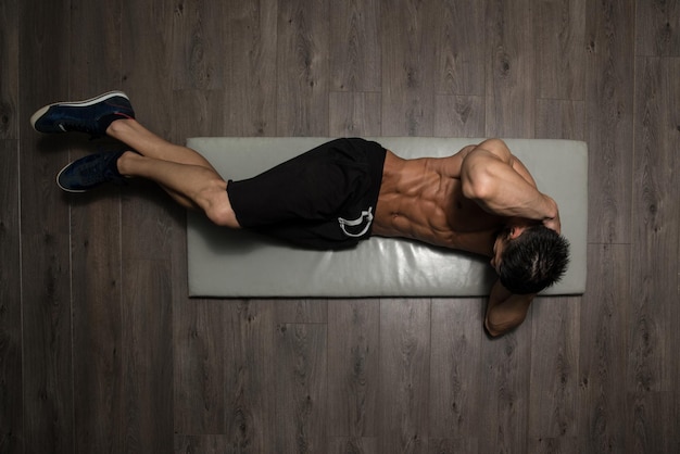 Healthy Man Exercising Abdominals On Foor