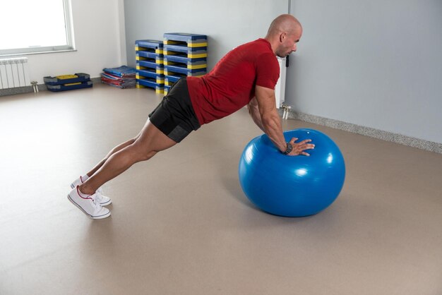 Healthy Man Stretches On Ball