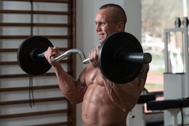 Healthy Man Working Out Biceps In A Health Club