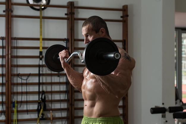 Healthy Man Working Out Biceps In A Health Club