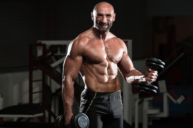 Healthy Man Working Out Biceps In A Health Club