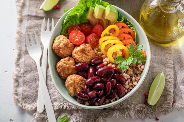 Healthy Mexican salad with meatballs beans pepper and groats