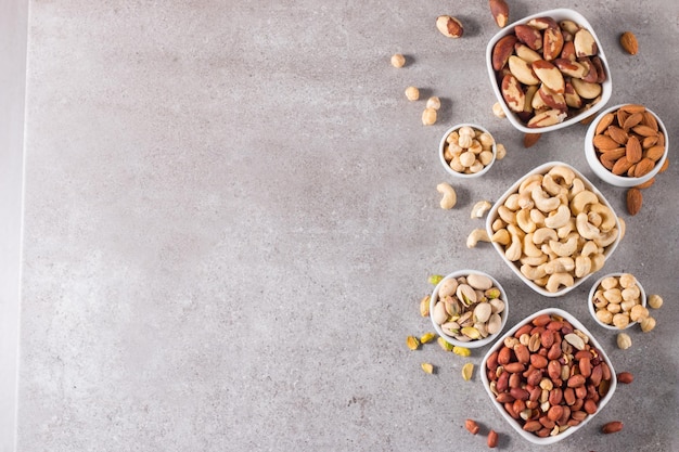 Healthy mix nuts and dried fruits on wooden background Almonds hazelnuts cashews peanuts