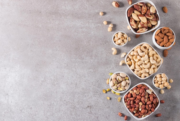 Healthy mix nuts on wooden background Almonds hazelnuts cashews peanuts pistachios Brazilian