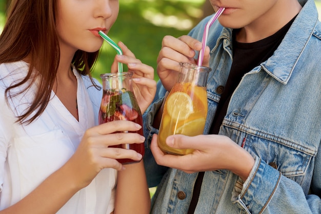 Healthy nutrition. Unrecognizable couple drinking fresh juice detox tea.