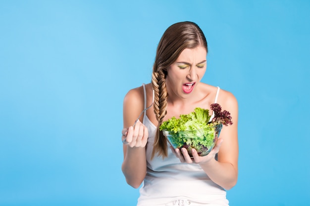 Healthy nutrition - young woman with salad